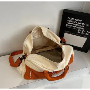 Large capacity canvas travel duffel bag with color block design for sports and gym.