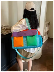 Color-blocked travel duffel bag, spacious interior, casual style for gym and weekend trips.