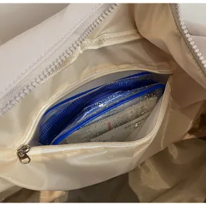 Travel bag interior detail, waterproof zipper pocket design, durable nylon lining storage.