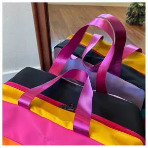 Detail shot of the color-blocked travel duffel bag showing vibrant multi-color panels.