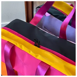 Colorblocked travel duffel bag, casual gym bag with sturdy straps and dual zippers for women.