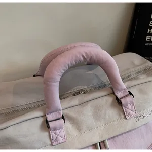 Detailed view of a stylish large capacity travel duffel bag with reinforced handle.