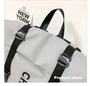 Close-up detail of grey roll-top waterproof backpack with durable black straps and buckles.