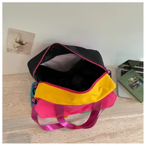 Colorful color-blocked travel duffel bag interior detail, spacious gym and luggage storage.