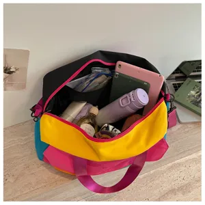 Close-up detail shot of the colorful color-blocked travel duffel bag showing interior storage.