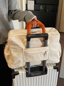 Large capacity travel duffel bag weekender luggage bag with trolley sleeve for women trips.