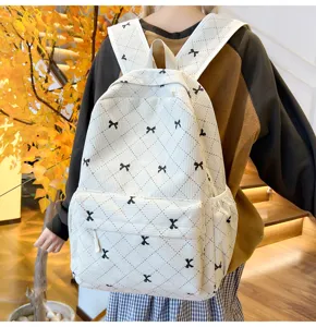 Sac à dos en velours côtelé avec joli nœud noir et motif losanges, idéal pour les étudiants.
