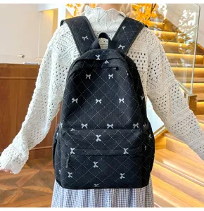 Sac à dos décontracté en velours côtelé noir avec motif losange et joli nœud pour voyage quotidien.