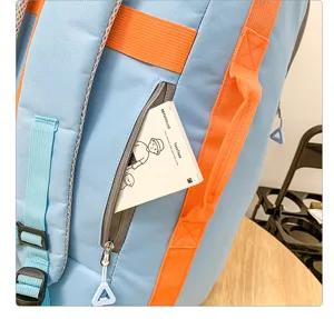 Vue détaillée montrant la poche color-block vibrante et les bretelles du sac à dos.