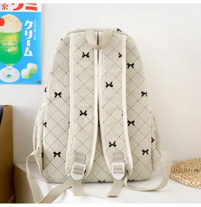 Sac à dos en velours côtelé avec nœud, grand volume et design simple pour étudiants.