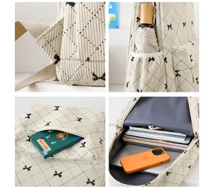 Détail du sac à dos en velours côtelé avec nœud, multi-poches et grande capacité pour l'école.