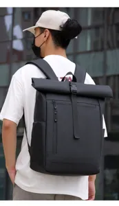 Detail view of black waterproof roll-top backpack with zipper pockets and adjustable straps.