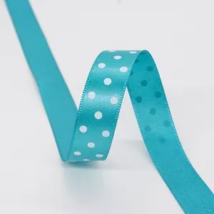 1.5cm blue polka dot polyester ribbon for gift wrapping, hair bows and crafts.