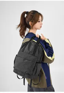 Detail view of the lightweight plaid oxford fabric backpack with dual shoulder and tote design.