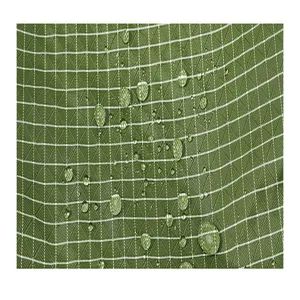 Waterproof green grid oxford fabric close-up detail, showing texture and water resistance.