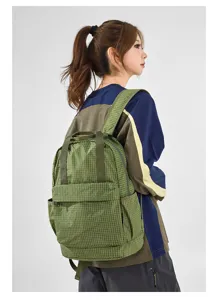 Detail view of the lightweight green plaid oxford cloth backpack with spacious compartment.
