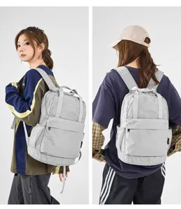 Lightweight grey plaid backpack for women, casual travel school bookbag with top handle.