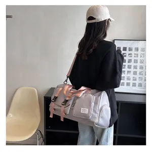 Large capacity multi-functional travel fitness duffel bag in grey with pink straps.