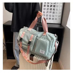 Detail view of large travel duffel bag with pink straps and multi pockets for fitness and trip.
