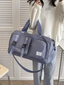 Large capacity travel duffel bag with separate shoe compartment for gym and sports use.
