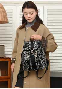 Detail view of stylish grey leopard print PU leather backpack closeup showing hardware.