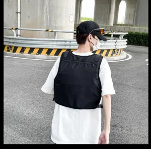 Black tactical vest chest bag detail view, multi-pocket outdoor street fashion style.