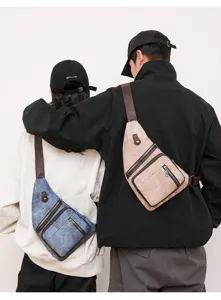 Casual crossbody sling chest bag detail showing multi zipper pockets and leather strap.