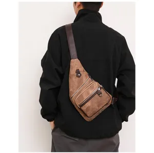 Casual canvas sling bag worn across the back, showcasing daily outdoor styling and wear detail clearly.