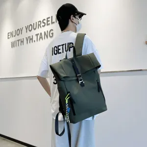 Minimalist dark green roll-top backpack worn by model, casual campus daypack for daily use.
