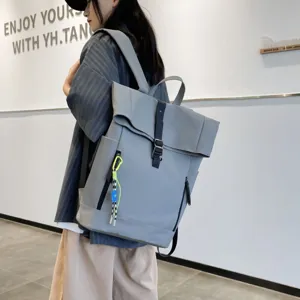 Detail view of grey casual backpack, large capacity and stylish design for daily use.