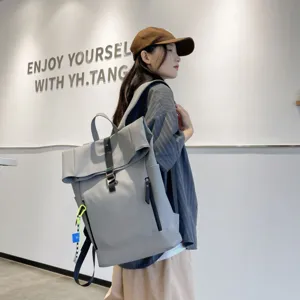 Casual large capacity solid color roll-top backpack for daily school and travel use.
