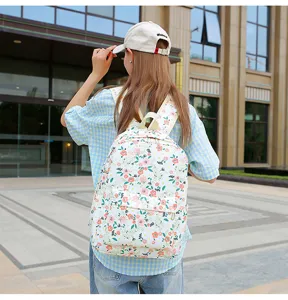 Detailed view of a floral student backpack, featuring a fresh botanical pattern and durable fabric.