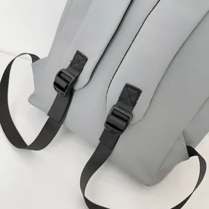 Grey backpack shoulder strap detail view, durable adjustable buckle and strap design.