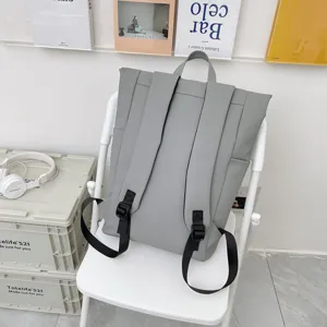 Casual gray backpack detail view showcasing shoulder straps and clean solid design aesthetics.