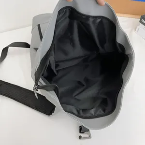 Grey casual large capacity backpack interior detail showing black lining and zipper pocket design.