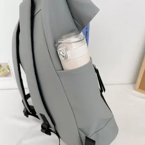 Detail view of the stylish grey casual backpack featuring a convenient side water bottle pocket.