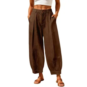 Casual loose-fitting brown cropped harem pants for women with pleated waist detail and sandals.