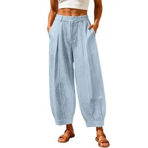 Detailed view of light blue loose harem pants with vertical seam texture.