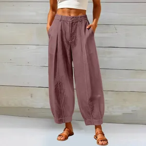 Detail view of women's loose solid color cropped harem pants in mauve with pockets