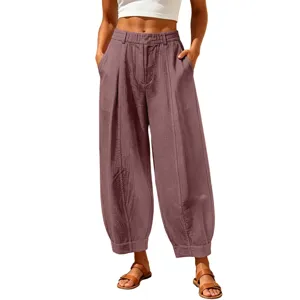 Detailed view of loose-fitting cropped harem pants in dusty rose showing fabric texture