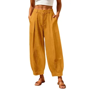 Detailed macro view showing the premium linen fabric texture of yellow harem pants