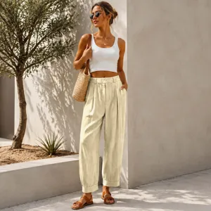 Lifestyle shot of a model wearing cream high-waisted harem pants with a white crop top