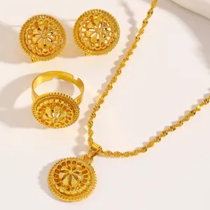 Detailed view of vintage Middle Eastern style gold-colored jewelry set featuring filigree motifs.