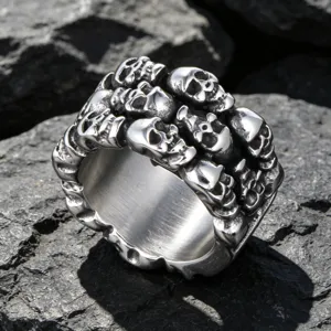 Vintage style stainless steel men's ring featuring multiple carved skulls on dark stone