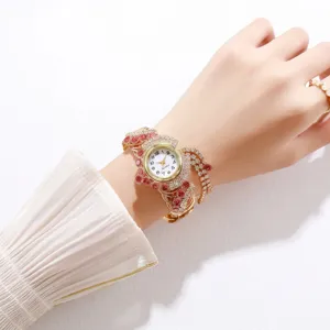 Elegant gold rhinestone bracelet watch for women featuring red crystal accents and tassels