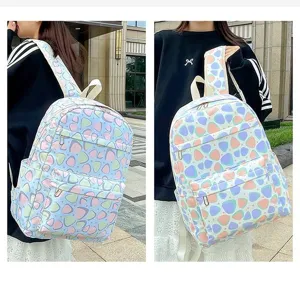 Detail view of a pastel abstract patterned school backpack, showing wear effect and details.
