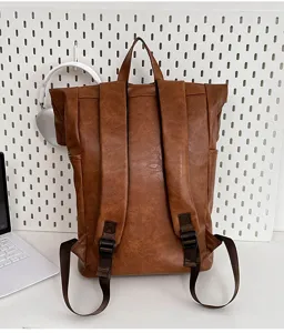Vintage brown PU leather roll top backpack for men and women casual travel computer daypack.