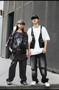 Detailed shot of trendy PU leather tactical chest bag harness worn by models outdoors.