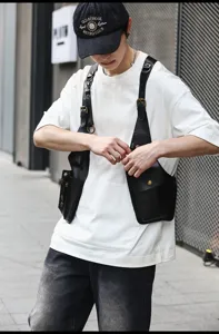 Stylish black PU leather tactical vest bag for men and women, trendy streetwear utility chest rig.