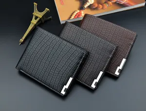 Detail view of men short wallet with crocodile texture, soft leather and metal corner decor.
